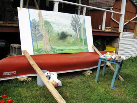 Big canvas sitting on canoe, tied to porch, stabilized by two-by-fours